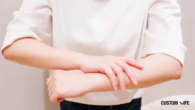 腕を見る女性